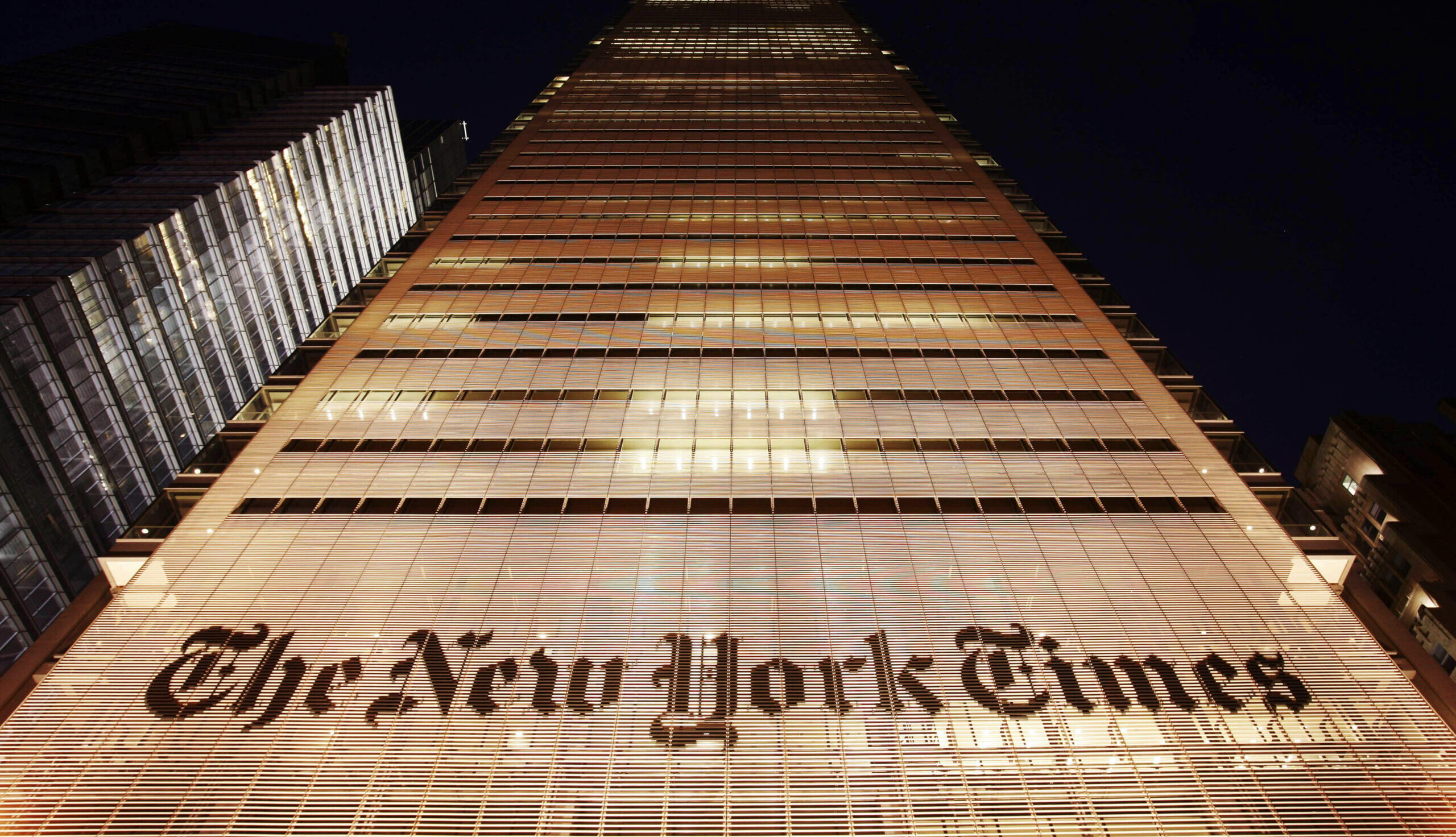 The New York Times building shown at night in NYC