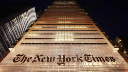 The New York Times building shown at night in NYC